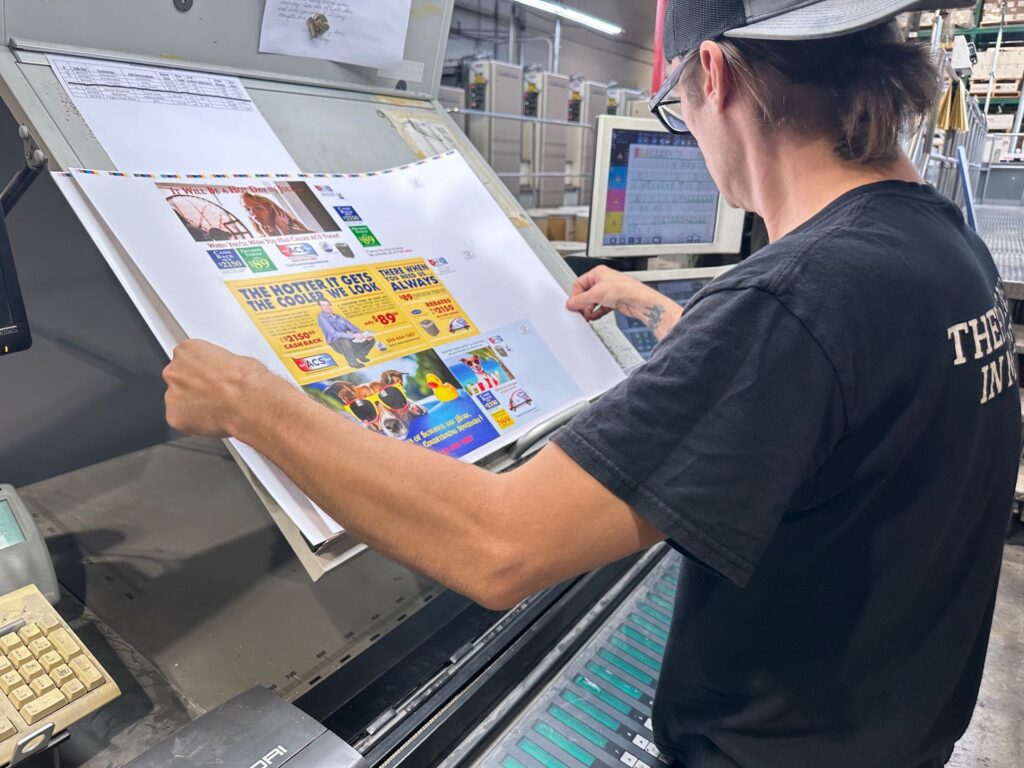 Press operator checking a colour proof